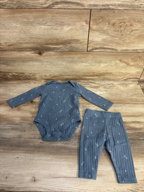 Flat lay of blue ribbed two piece baby set, long sleeve bodysuit and leggings with small white floral print on wood background