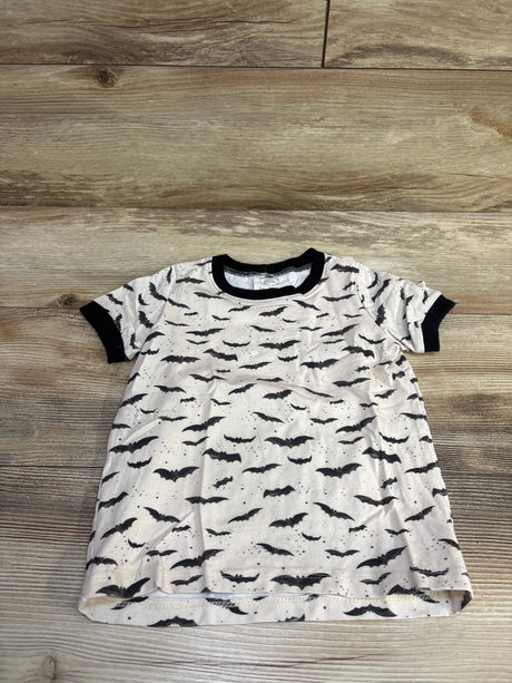 Front view of Kait Perez bat shirt showcasing ivory fabric with black bat print and black trim on a wood background
