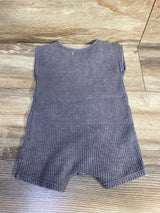 Flat lay of Grayson mini knit romper showcasing grey waffle knit texture and short leg cut on light wood floor
