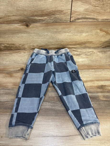 Kids blue and gray checkered jogger pants with drawstring and cuffed ankles on wood floor