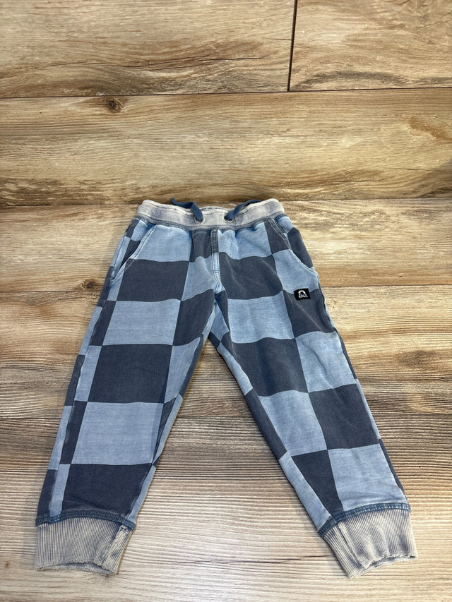 Kids blue and gray checkered jogger pants with drawstring and cuffed ankles on wood floor