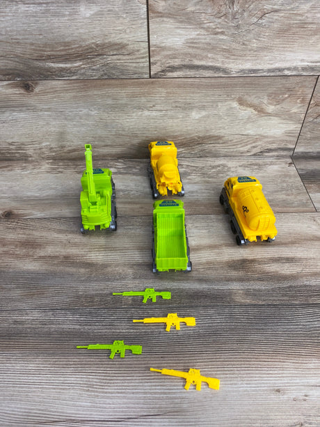Children's toy construction trucks and toy rifles in yellow and green on a wood floor background