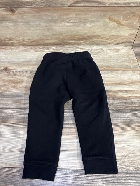 Front view of black Old Navy Dynamic Fleece Joggers, size 2T, with elastic waistband and ribbed cuffs on wood flooring