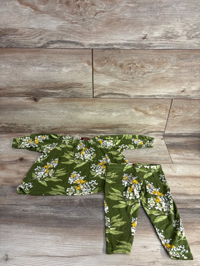 Green floral baby outfit set with long sleeve top and leggings on wood background