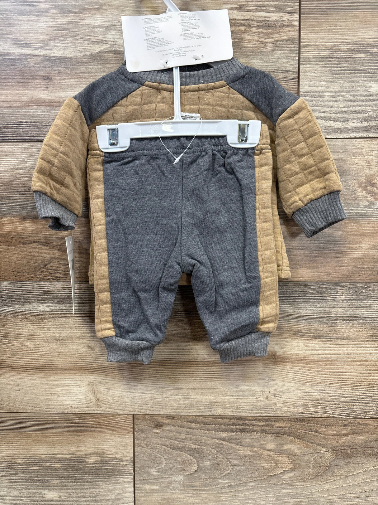 Infant outfit set with gray and tan quilted long sleeve top and matching pants on hanger
