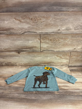 Front view of Carhartt long-sleeve toddler shirt (12 months) with brown dog graphic on green fabric, wood background