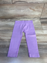 Flat lay of lilac toddler ribbed leggings size 12-24 months with elastic waistband and ribbed texture on wood floor