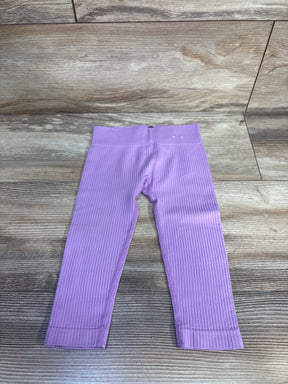 Flat lay of lilac toddler ribbed leggings size 12-24 months with elastic waistband and ribbed texture on wood floor