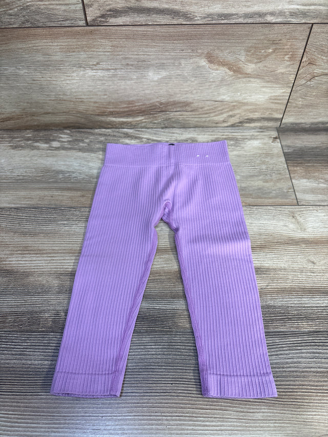 Flat lay of lilac toddler ribbed leggings size 12-24 months with elastic waistband and ribbed texture on wood floor