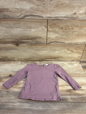 Top view of H&M purple long-sleeve shirt showcasing a crew neck and long sleeves on a wood-look floor