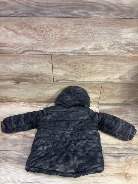 Back view of AQ Explore The Unknown black lined puffer jacket showcasing its hood and quilted panels on a wood floor