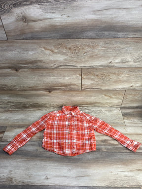 Orange and white plaid long sleeve button-up shirt on wooden floor background