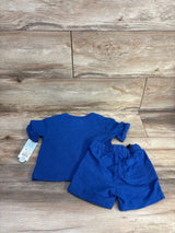Flat-lay of Cat & Jack blue toddler French terry shirt and shorts showing knit texture and tags on wood background, size 12 months