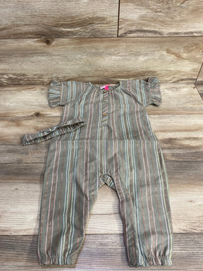 Flat-lay of Penelope Mack olive coverall with ruffle sleeves, button front, elastic ankles and matching headband on wood floor
