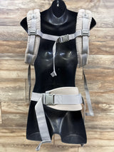Front of Ergobaby Omni 360 carrier in beige with padded adjustable straps, chest clip and wide waist belt on black mannequin