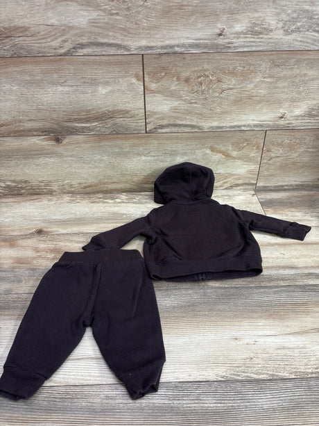 Back view of Baby Gap two-piece zip-up hoodie and joggers set in black with a hood and cuffed hems on a wood-look background