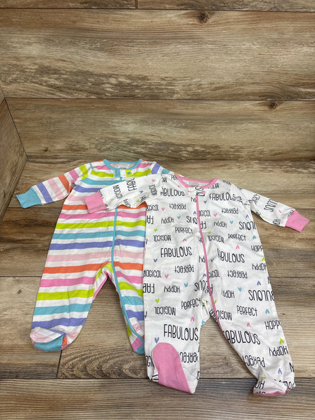 Top view of Gerber 2pk Sleep N’ Play Sleepers showcasing multicolor stripes and white word print on a wood background