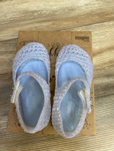 Top-down view of Mini Melissa Campana Papel jelly flats in pearly blue showing lattice cutout upper and Mary Jane strap on cardboard box