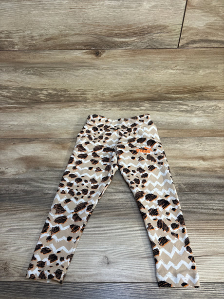 Kids leopard print leggings with chevron pattern, Puma logo, laid on wood floor