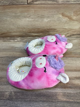 Pink unicorn plush baby slippers with purple mane and horn on wooden floor