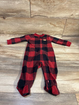 Top view of Child Of Mine blanket sleeper showcasing a red and black plaid pattern, front zipper, and enclosed feet on wood flooring