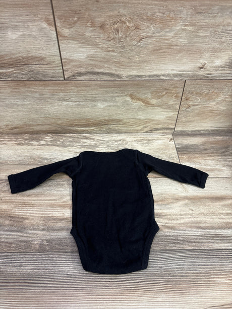 Front view of Rabbit Skins My First Hockey Season Bodysuit, black with long sleeves, size 6m, on a wood-grain floor