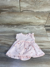 Flat lay of pink ribbed Carter's Firefly bodysuit dress showing ruffled cap sleeves and dragonfly print skirt on wood floor background