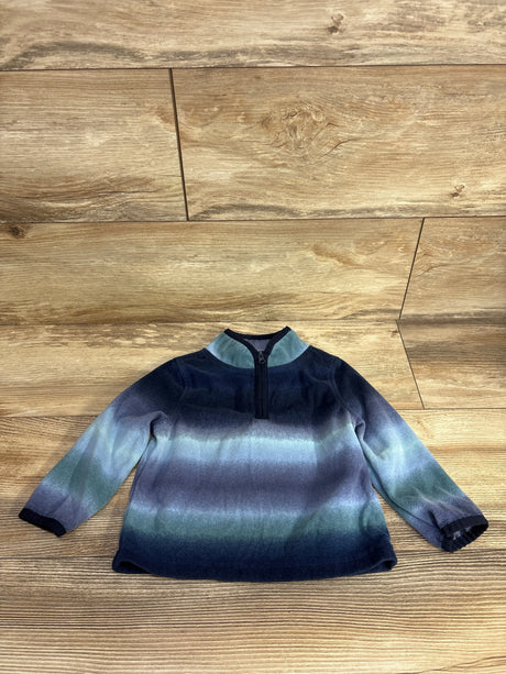 Long sleeve toddler pullover sweater with blue and green ombre stripes on wood floor