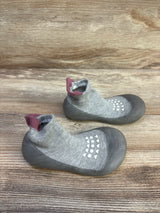 Top-down view of Bearbay grey sock shoes (size 7/8C) showing rubber soles, white non-slip grip dots, and ankle sock cuffs on a wooden background