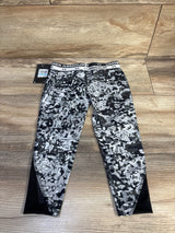 Flat lay of Under Armour girls' grey camo leggings (size 5T) showing branded elastic waistband and black mesh ankle panels on wood floor