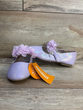 Three-quarter view of Gymboree lavender ballet flats size 9C showing glitter finish and flower straps on wood floor