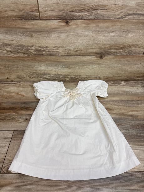 Front view of Zara ivory short sleeve flower applique dress, size 4-5T, showcasing a flower applique on a wood floor