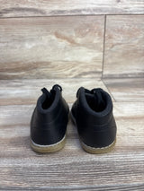 Rear view of Teeny Toes Oxford first walker baby shoes in black showing stitched gum sole and pull tabs on wood floor