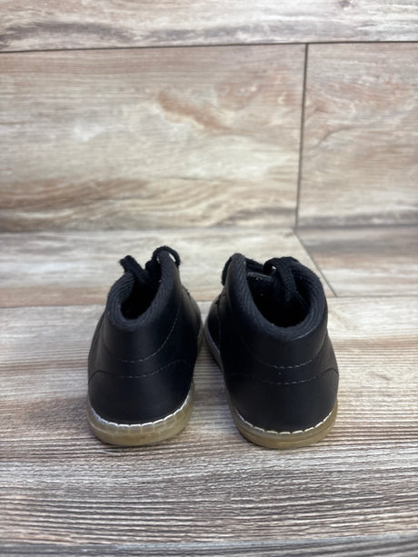 Rear view of Teeny Toes Oxford first walker baby shoes in black showing stitched gum sole and pull tabs on wood floor