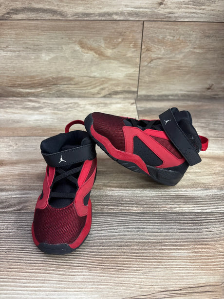 Pair of Air Jordan Lift Off TD sneakers showing black, white, and gym red panels on wood flooring