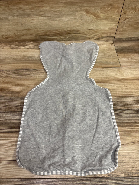 Flat view of Love To Dream Swaddle Up Original in gray, size Small/Newborn, showcasing striped trim on a wood-look floor