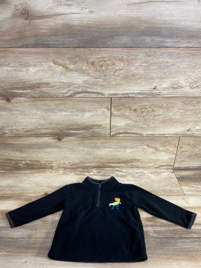 Black toddler fleece pullover with rainbow dinosaur embroidery on wood background