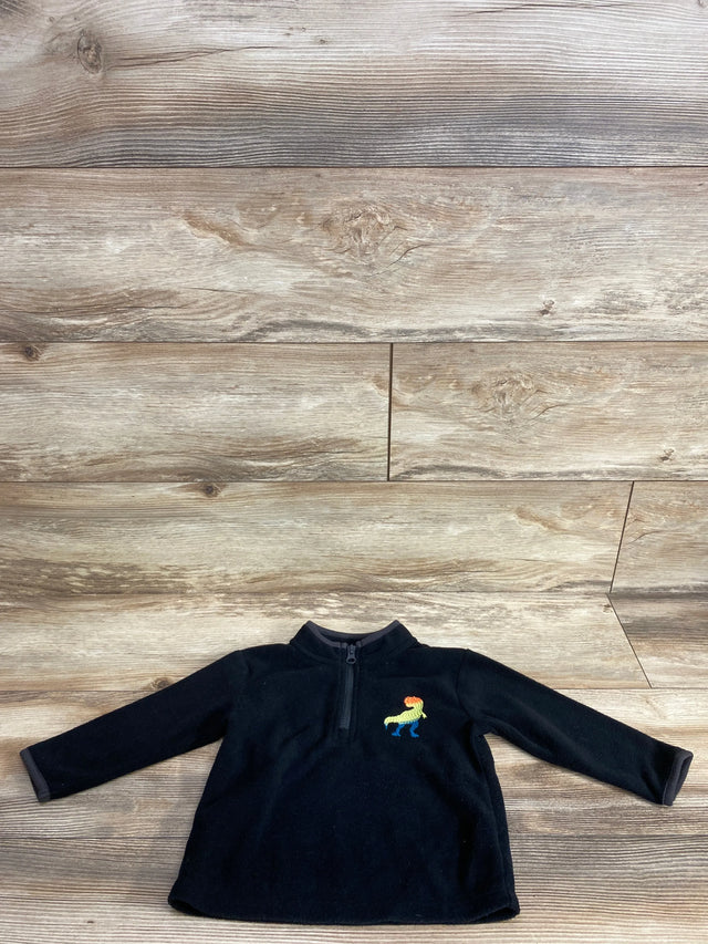 Black toddler fleece pullover with rainbow dinosaur embroidery on wood background