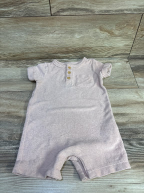 Top down view of Little Planet Organic henley terry romper (12m) showing three wooden buttons and chest pocket on wood floor