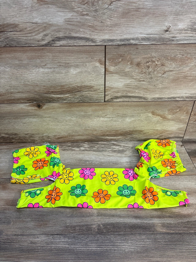 Bright yellow kids' swimsuit set with colorful smiley face flowers on wooden background