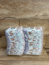 Front view of a sleeve of 80 Luvs Paw Patrol size 2 diapers showcasing character print on a wood background