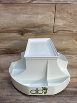 Front view of Dexbaby changing station in white showing rotating base with four compartments and removable top tray