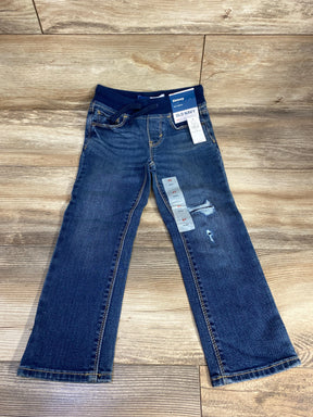 Front view of Old Navy distressed skinny jeans size 4T showing elastic rib waistband and knee rips on wood floor