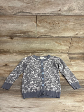 Gray button-up children's cardigan with bird and birdcage pattern on wooden background