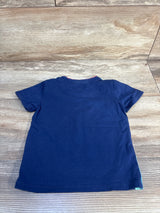 Navy blue short sleeve kids t-shirt laid flat on wood background