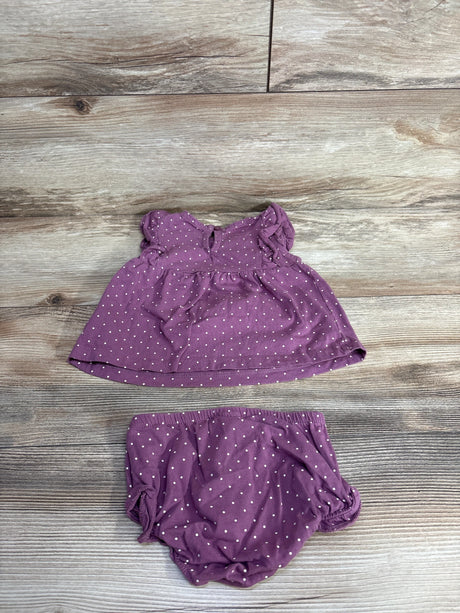 Purple polka dot baby dress and matching diaper cover laid on wooden floor, toddler clothes