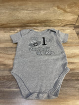 Gray baby bodysuit with "My 1st football season" and a football graphic on wood background
