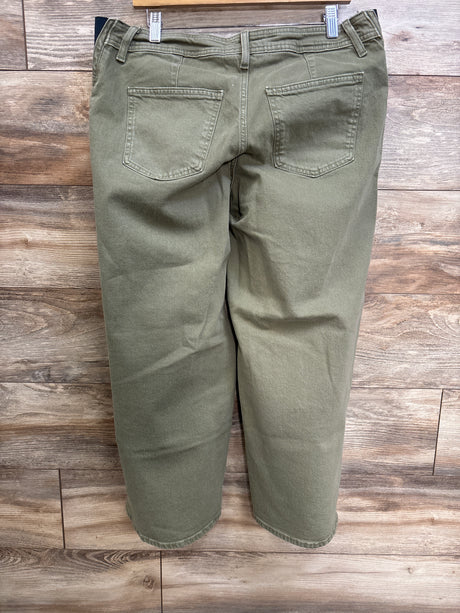 Back view of green Isabel maternity wide-leg jeans showing side-panel waist and back pockets against wood background