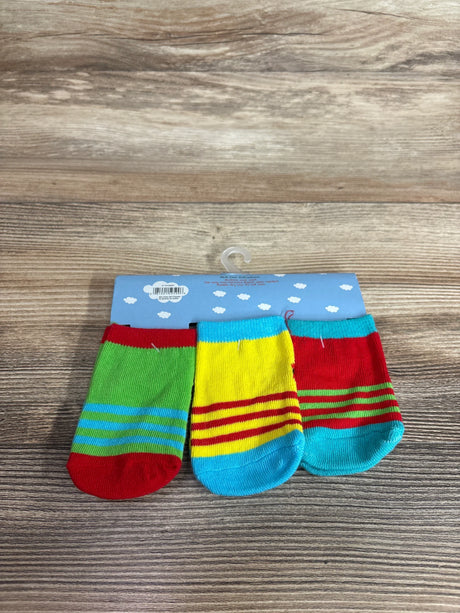 Front view of 3-pack baby socks (size 0-12M) showing bright stripes on a display card on a wood tabletop