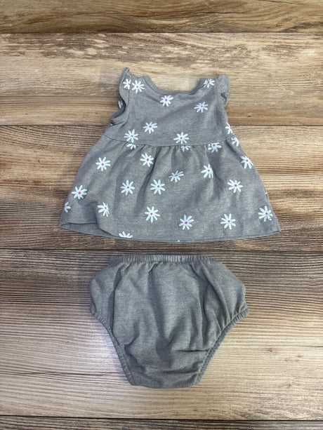 Top-down view of Cat & Jack 2pc newborn gray dress and bloomers set with floral print on a wood surface